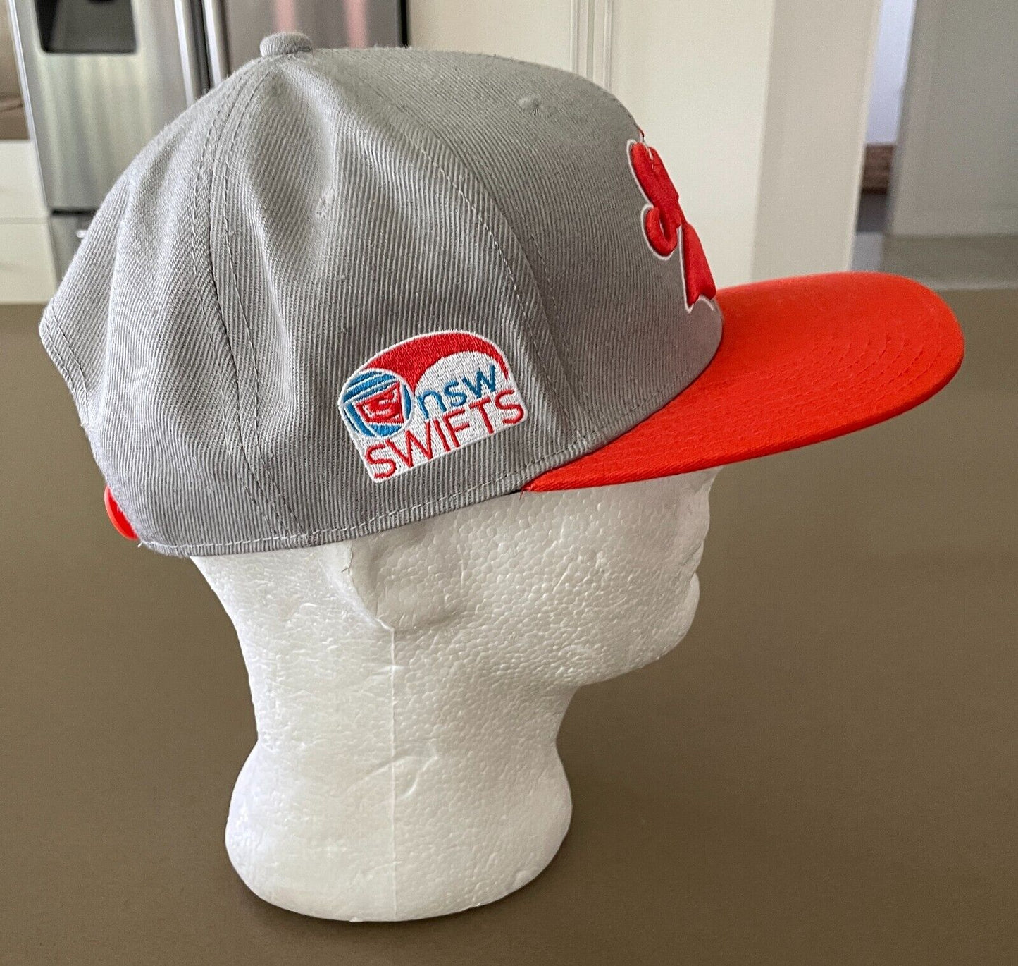 Fan Cap NSW SWIFTS Netball Taupe and Orange Fan Adjustable Flat Bill Hat OSFM