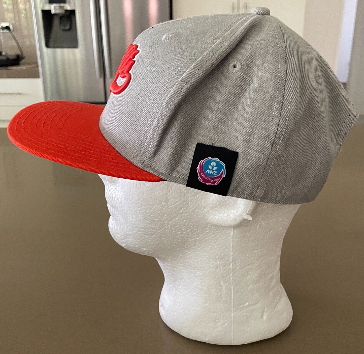Fan Cap NSW SWIFTS Netball Taupe and Orange Fan Adjustable Flat Bill Hat OSFM